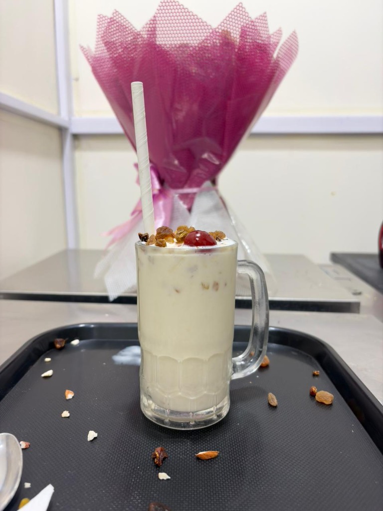 Creamy vanilla shake with raisins and cherry